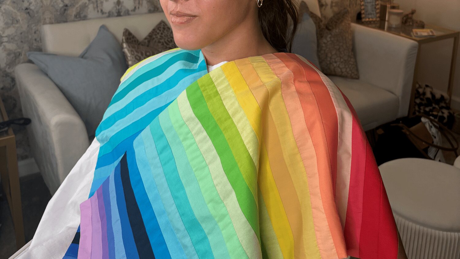 A client wearing colorful drapes during a Color Lab STL color analysis session